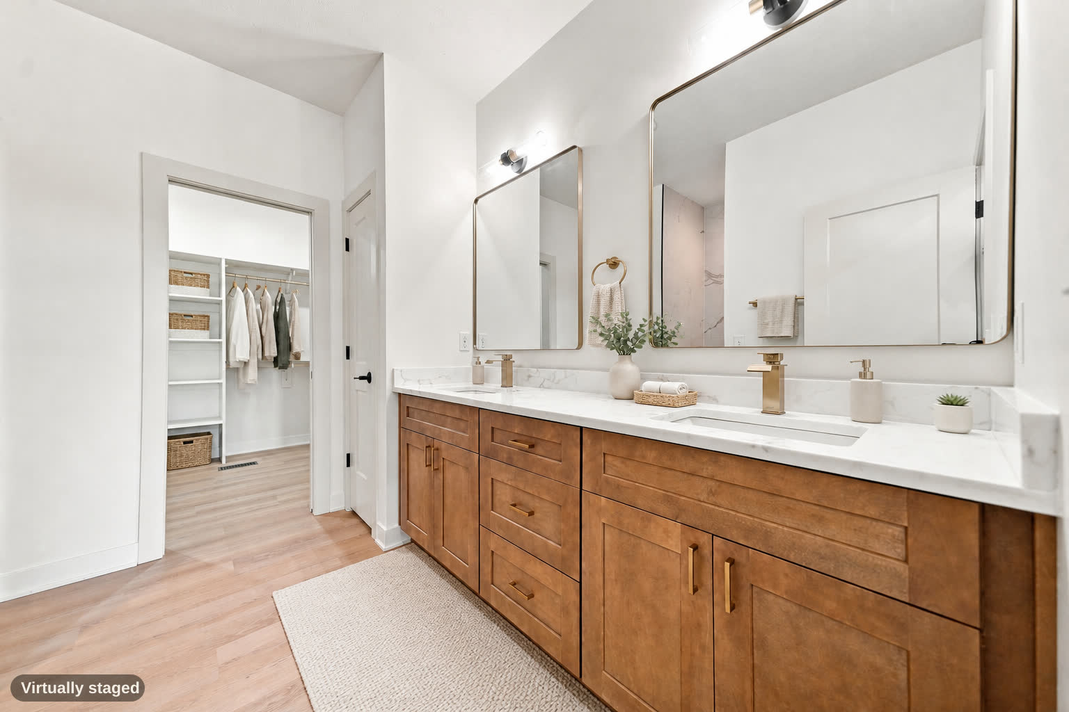 Same bathroom, virtually staged with towels, plant, rug, and closet clothes.