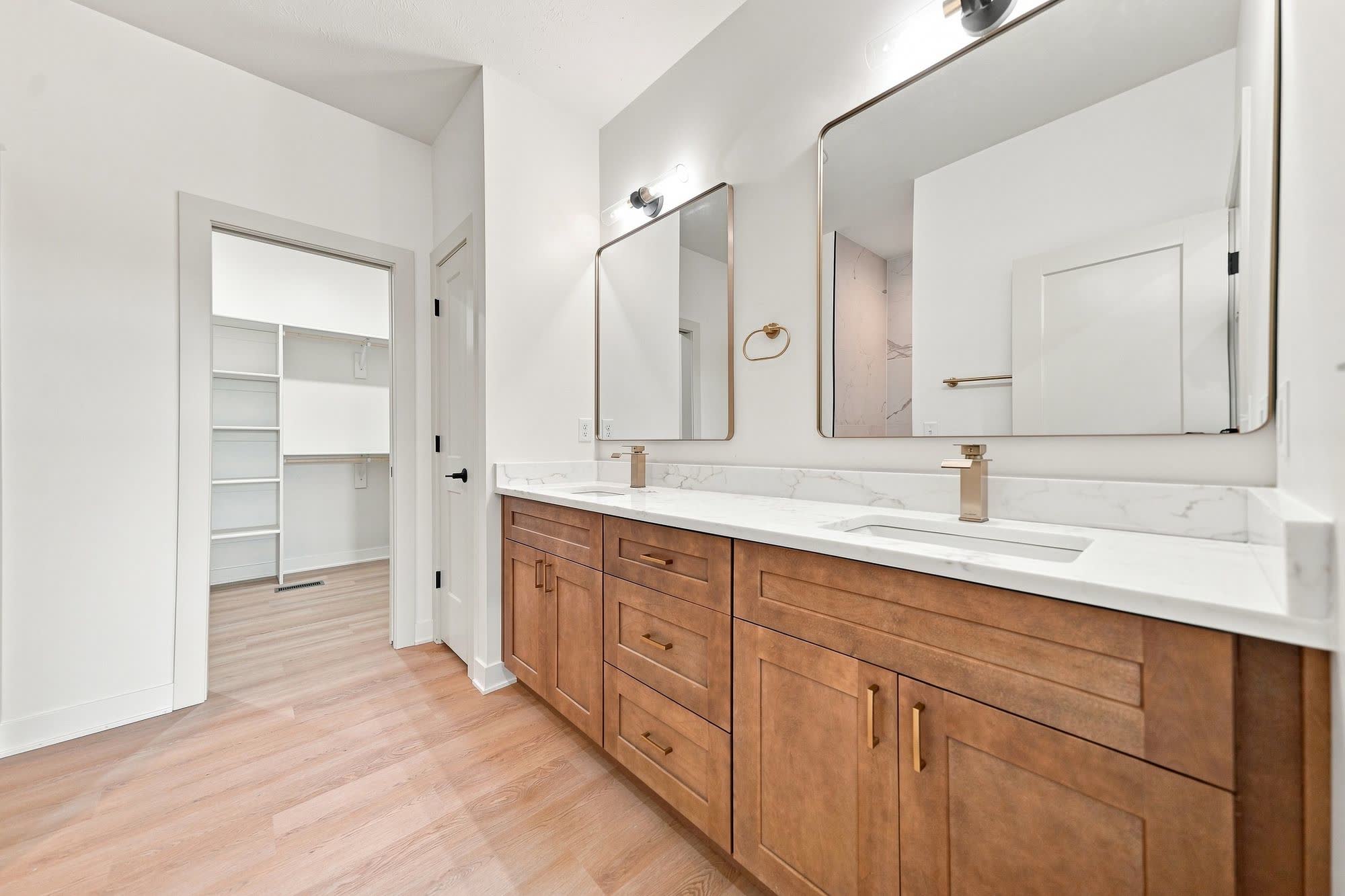 Empty double-vanity bathroom with no accessories.