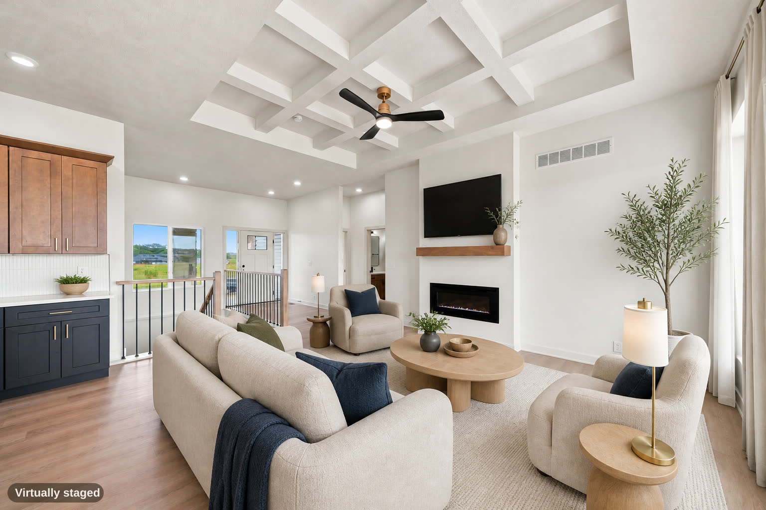 Same living room, virtually staged, open to the kitchen.