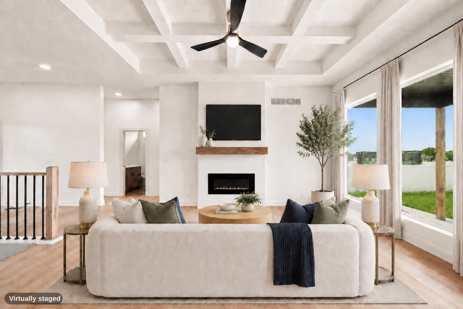 Same living room, virtually staged, fireplace at center.
