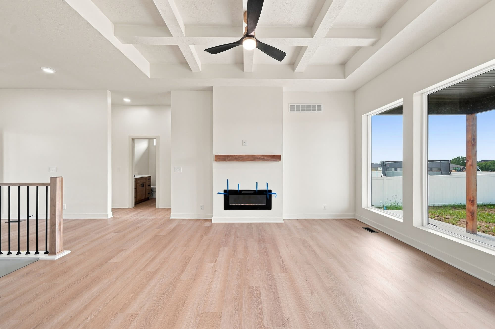 Empty living room centered on the fireplace.
